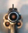 loaded revolver aimed at the viewer