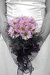 bride holding bouquet with picture in black and white but flower