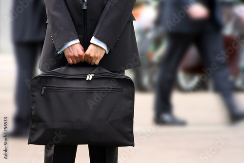 Photo: business man holding briefcase at rush hour business man holding briefcase at rush hour