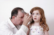 doctor examining a child's ear