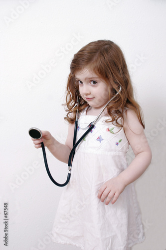 little girl playing with stethoscope
