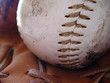 close up of baseball and ball glove