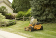 gardener riding large orange mower