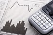Foto: mobile phone over charts mobile phone over charts