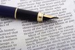 pen over newspaper