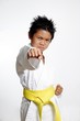 boy with yellow belt practicing karate