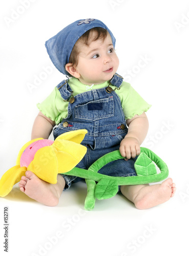 baby girl holding flower