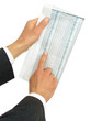 hands holding newspaper with stock reports