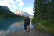 a couple on a dock in the mountains