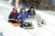 Foto: three kids sledding three kids sledding
