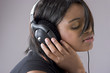 attractive young black woman listening to music on