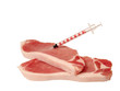 syringe in a pork meat piece