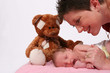 baby being watch by loving mother