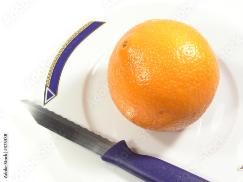 Photo: orange, knife and a plate orange, knife and a plate