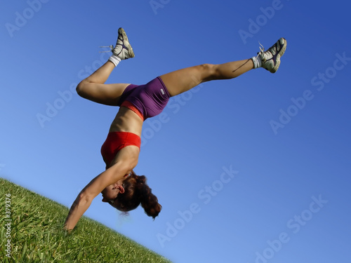 Photo: girl exercising outdoors on the grass girl exercising outdoors on the grass