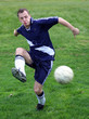 soccer player hitting a ball