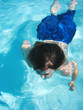 young boy swimming under water