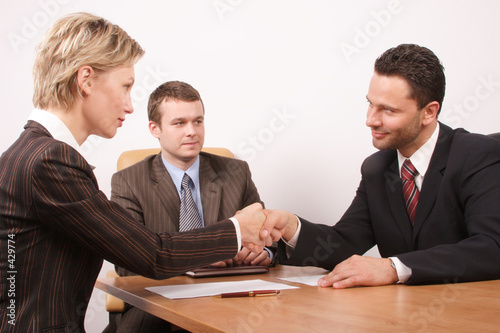 Photo: negotiation over,man and woman handshake negotiation over,man and woman handshake