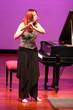 beautiful girl playing flute at the concert
