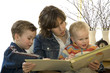 mother and two son's reading a book