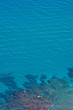 aerial view of clear blue water and yellow boat aerial view of clear blue water and yellow boat