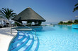 tiki hut and bar by swimming pool of luxury hotel