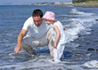 father and daughter playing in the sea