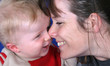 close up of young mother and son sharing a joke.