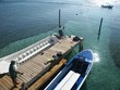 mole on coast of roatan with boats