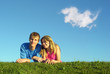 couple lies on meadow with cloud