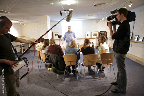 video crew filming meeting with movement blur video crew filming meeting with movement blur