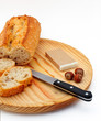 pate, bread, hazelnuts and knife on wood plate