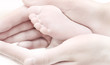 child foot in the mother hands child foot in the mother hands