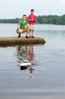 father and son playing with a boat
