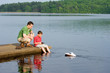 father and son playing with a boat