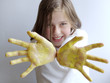 girl with yellow painted hands