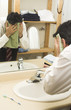 man drying his face with towel