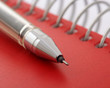 pen on red notebook