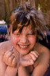 young girl gets water over the head