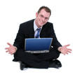 Photo: business man sitting on floor with laptop hands ou business man sitting on floor with laptop hands ou