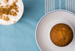 cup of coffee with cinnamon and muffin on the plat