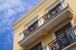 yellow apartment building, blue sky yellow apartment building, blue sky