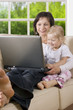 clipping path! mother with daughter on the sofa