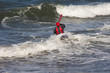 man canoeing into waves