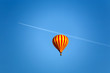 ballon and an airplane with slipstrem on the blue