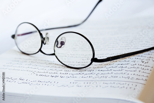glasses on arabic book