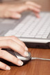 hand on mouse and keyboard blured