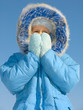 girl trying to warm her face