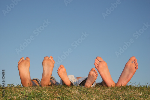 family legs on grass