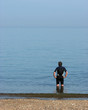 man standing in sea man standing in sea